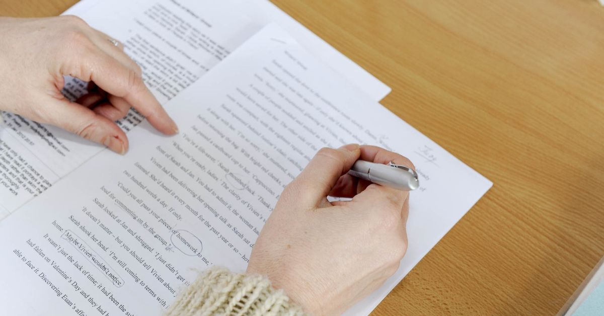 a writer making corrections on a paper