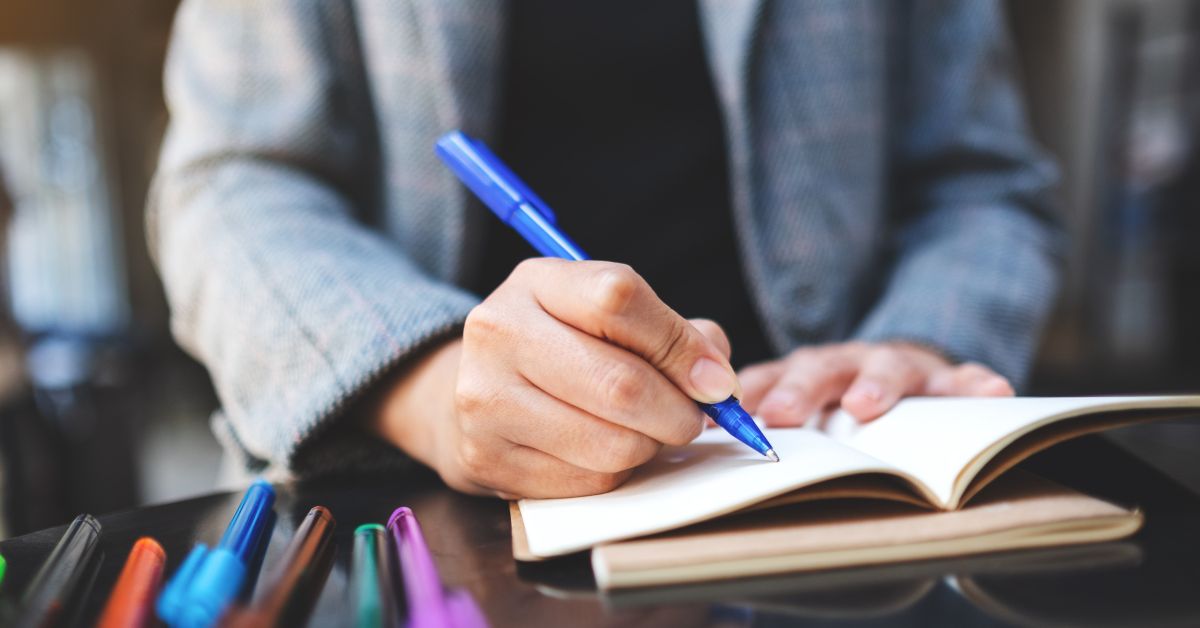 an author writing on his notebook