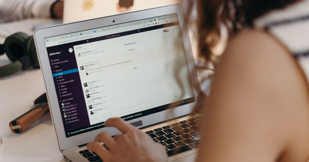 A girl having a chat with someone through her laptop