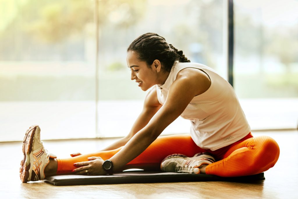 woman stretching. Photo by Jonathan Borba via Pexels